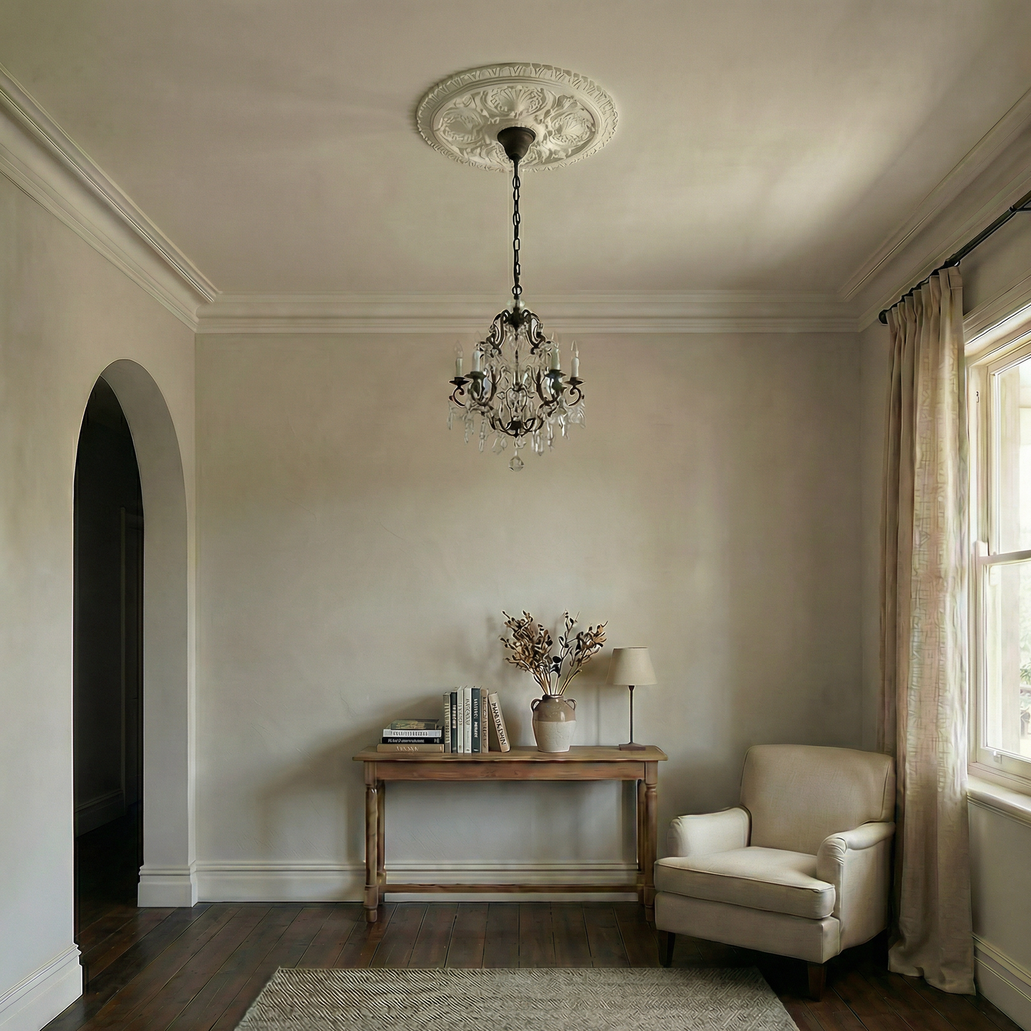 Traditional plaster ceiling rose with ornate chandelier in a period Tasmanian interior, featuring soft neutral walls, classic cornice detailing, timber floorboards and restrained furnishings.
