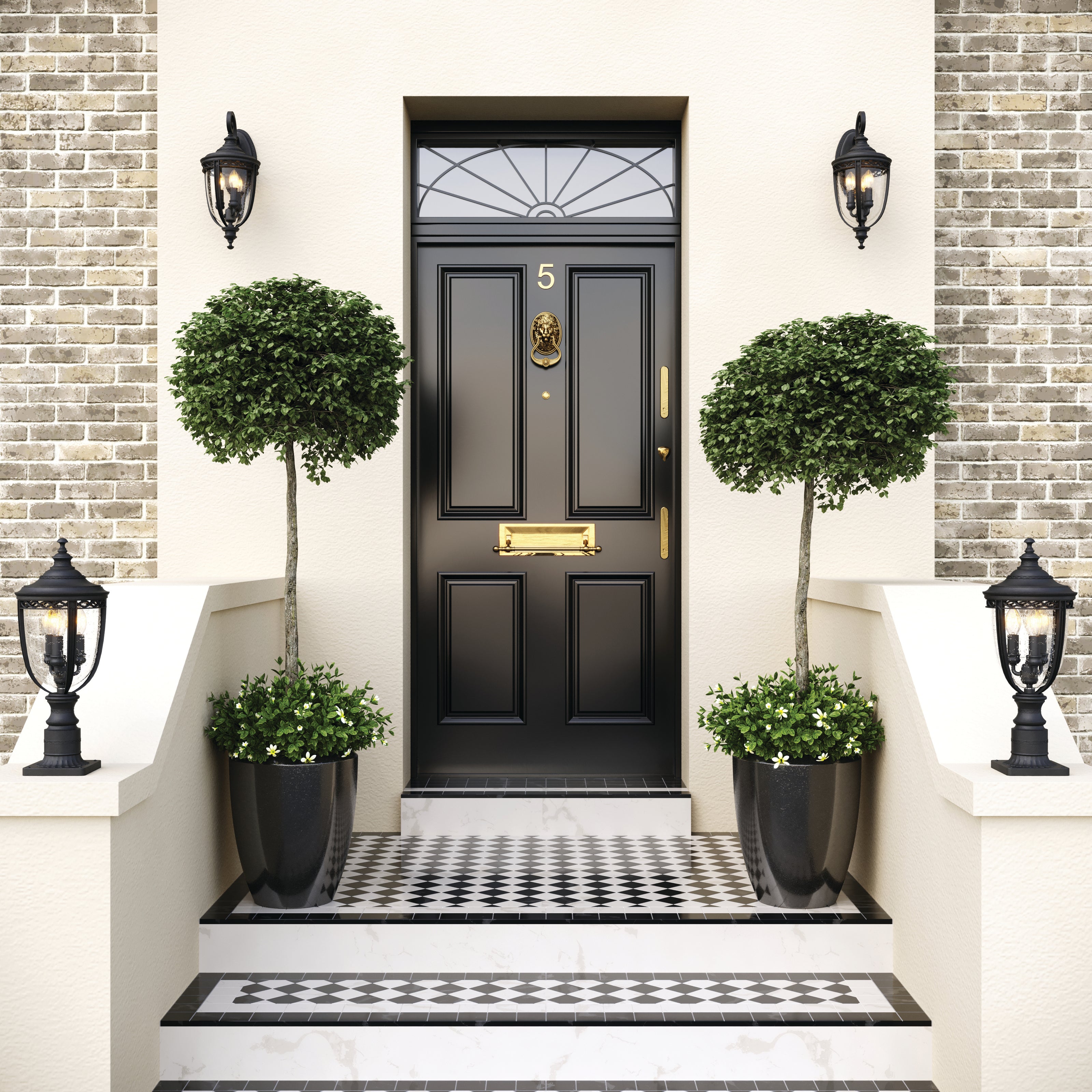 Black front door with brass hardware flanked by potted topiary plants and black wall and pillar lights with traditional black and white tiled entry.
