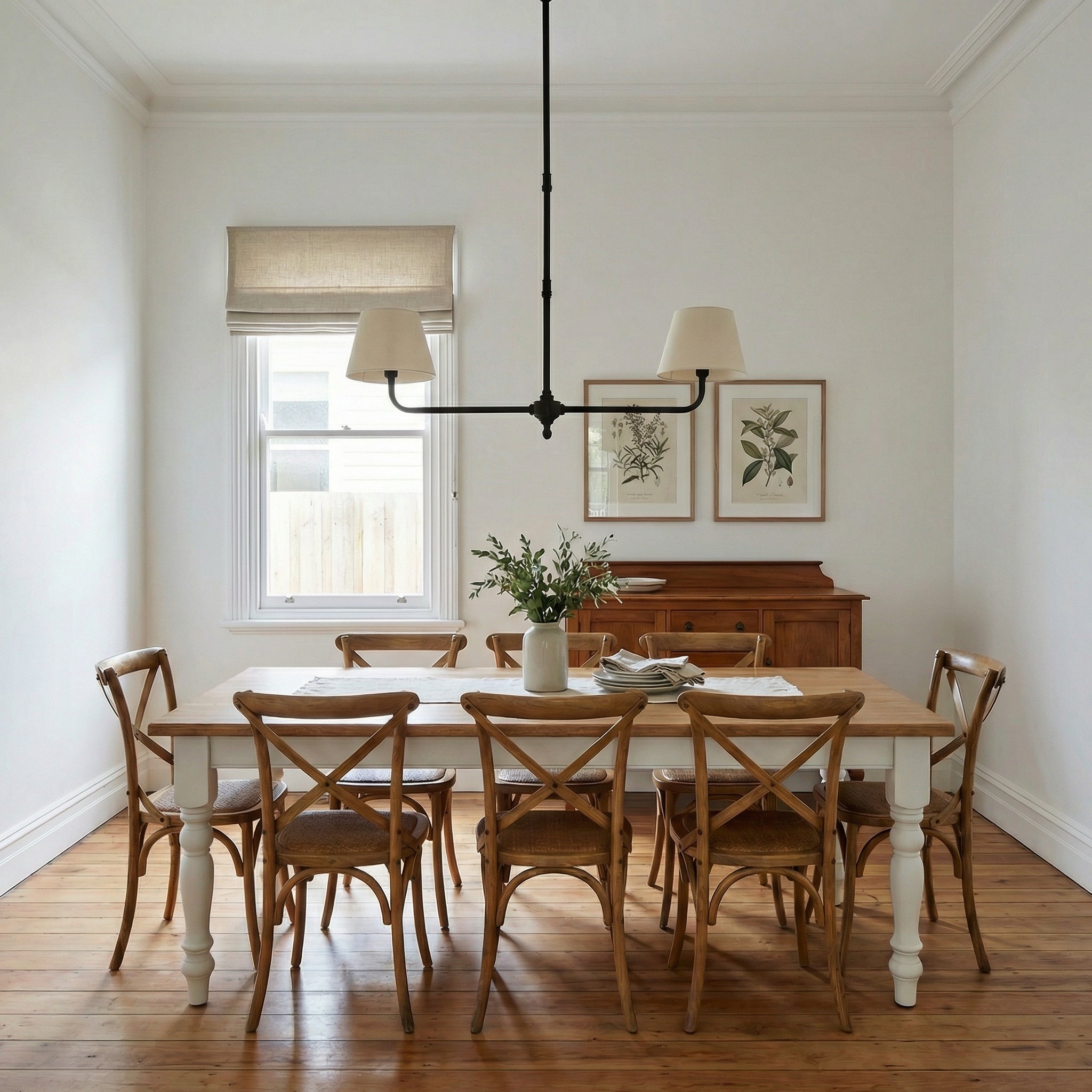 Traditional two-arm ceiling light with fabric shades centred above a timber dining table in a Federation-era dining room with painted woodwork, Roman blind, original floorboards, and period furniture.